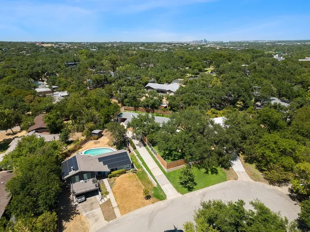 an aerial view of residential house with green space