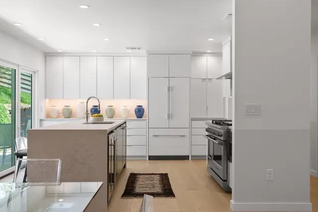 a kitchen with sink cabinets and stove top oven