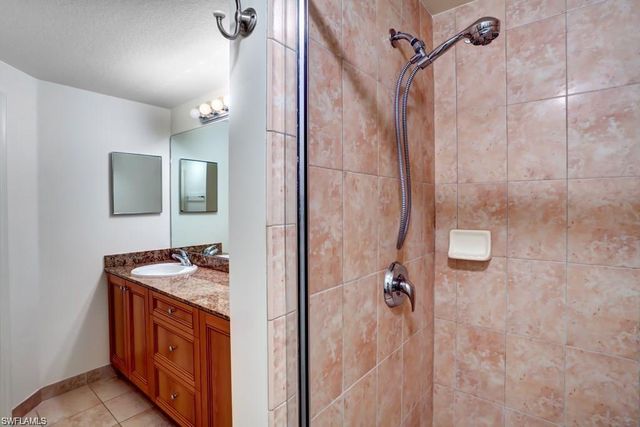 a bathroom with a sink a vanity and shower