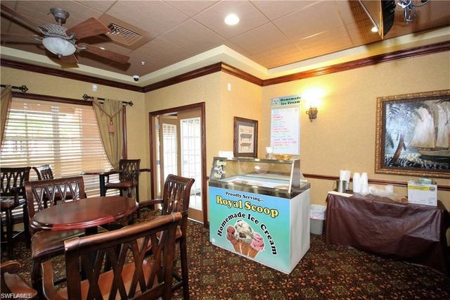 a dining room with furniture and a flat screen tv