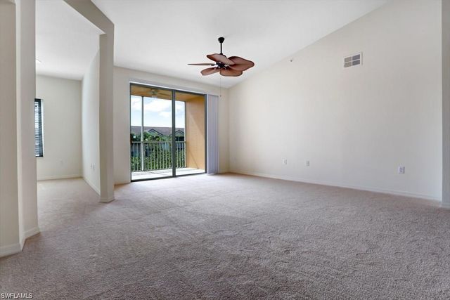 a view of a livingroom with a ceiling fan and window