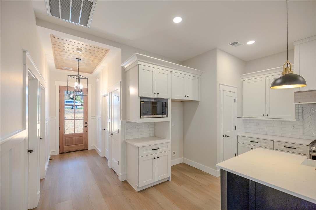 1409 Stonehurst Road Anderson, SC 29621 - Photo 37 of 37 This modern kitchen and entryway seamlessly blend style and functionality for daily living.