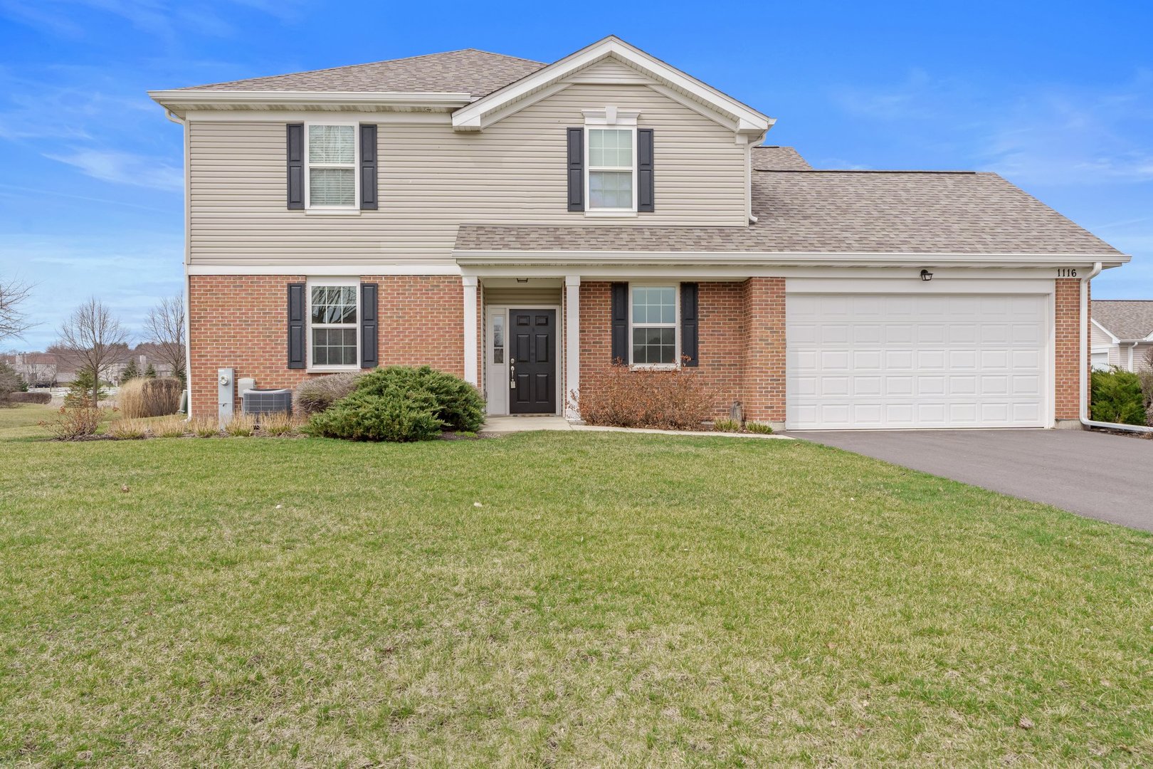 1116 Draper Road, Unit 1116 McHenry, IL 60050 - Photo 1 of 20 a front view of a house with garden