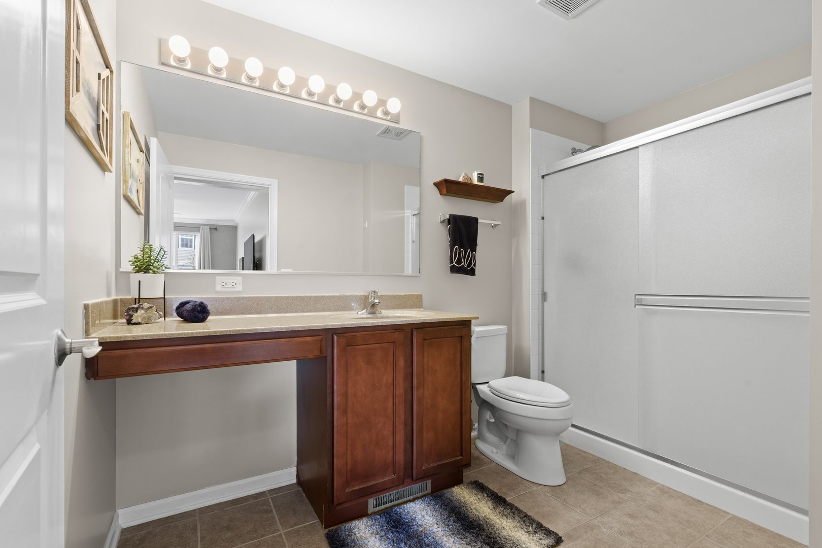 1116 Draper Road, Unit 1116 McHenry, IL 60050 - Photo 13 of 20 a bathroom with a sink mirror toilet and a shower