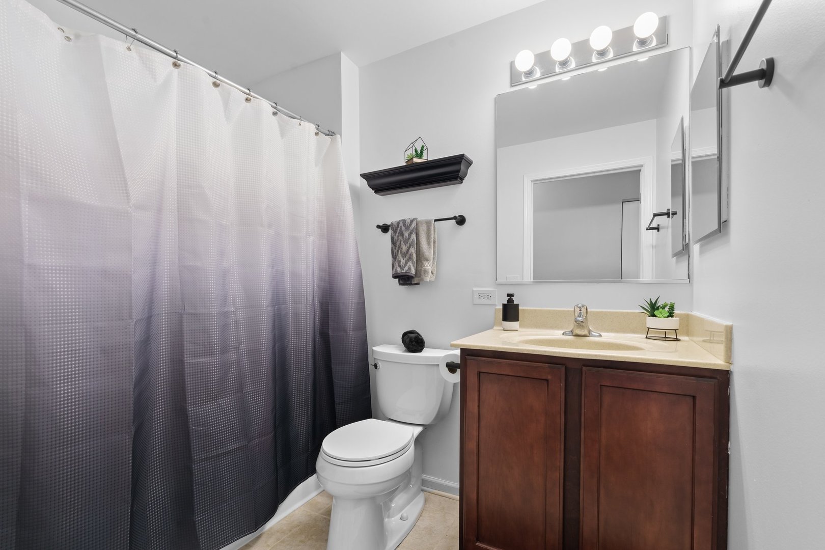 1116 Draper Road, Unit 1116 McHenry, IL 60050 - Photo 16 of 20 a bathroom with a sink a toilet and shower