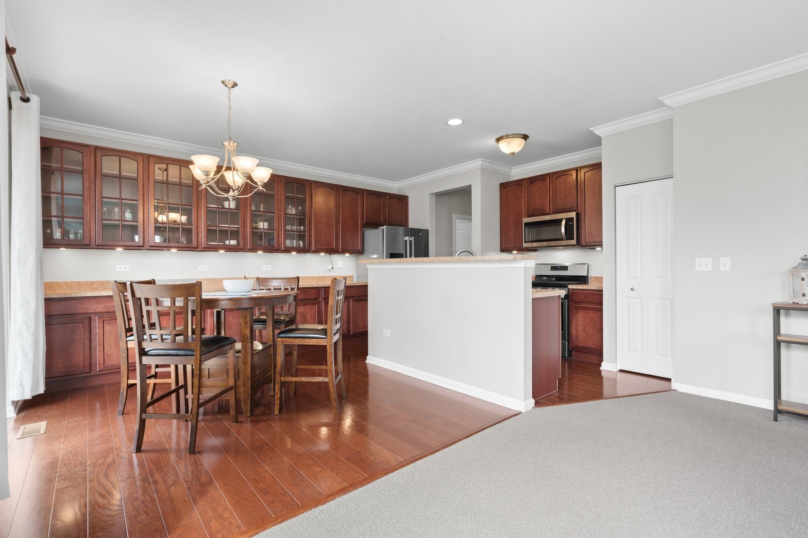 1116 Draper Road, Unit 1116 McHenry, IL 60050 - Photo 7 of 20 a view of a dining room with furniture window and wooden floor
