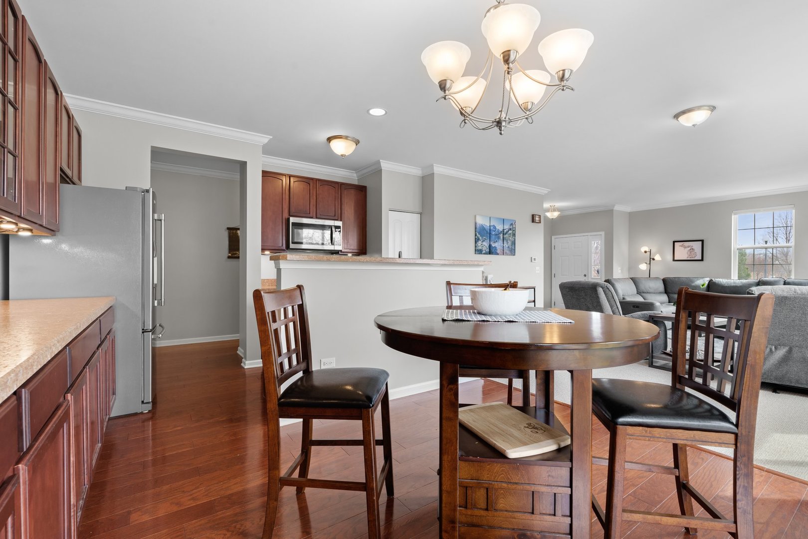 1116 Draper Road, Unit 1116 McHenry, IL 60050 - Photo 8 of 20 a view of a dining room with furniture and chandelier