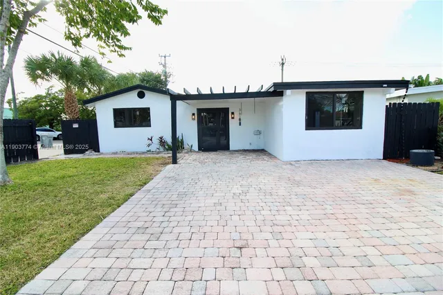 a front view of a house with a yard and a garage