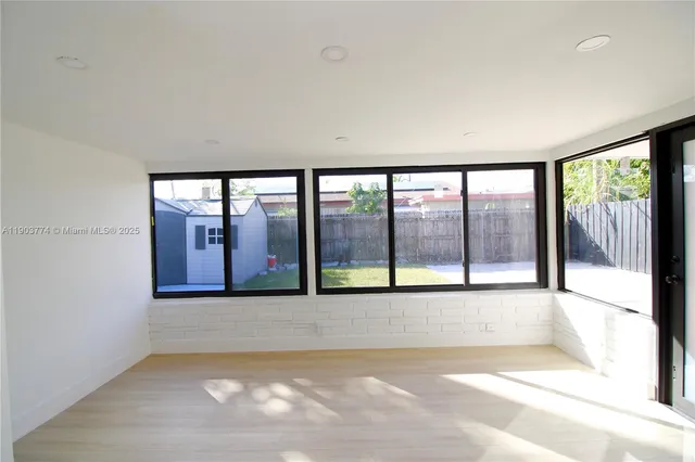 a view of an empty room with a large window