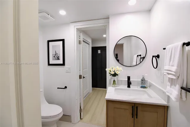 a bedroom with a large bed and a painting on the wall