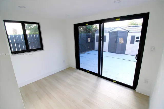 a view of hallway with wooden floor