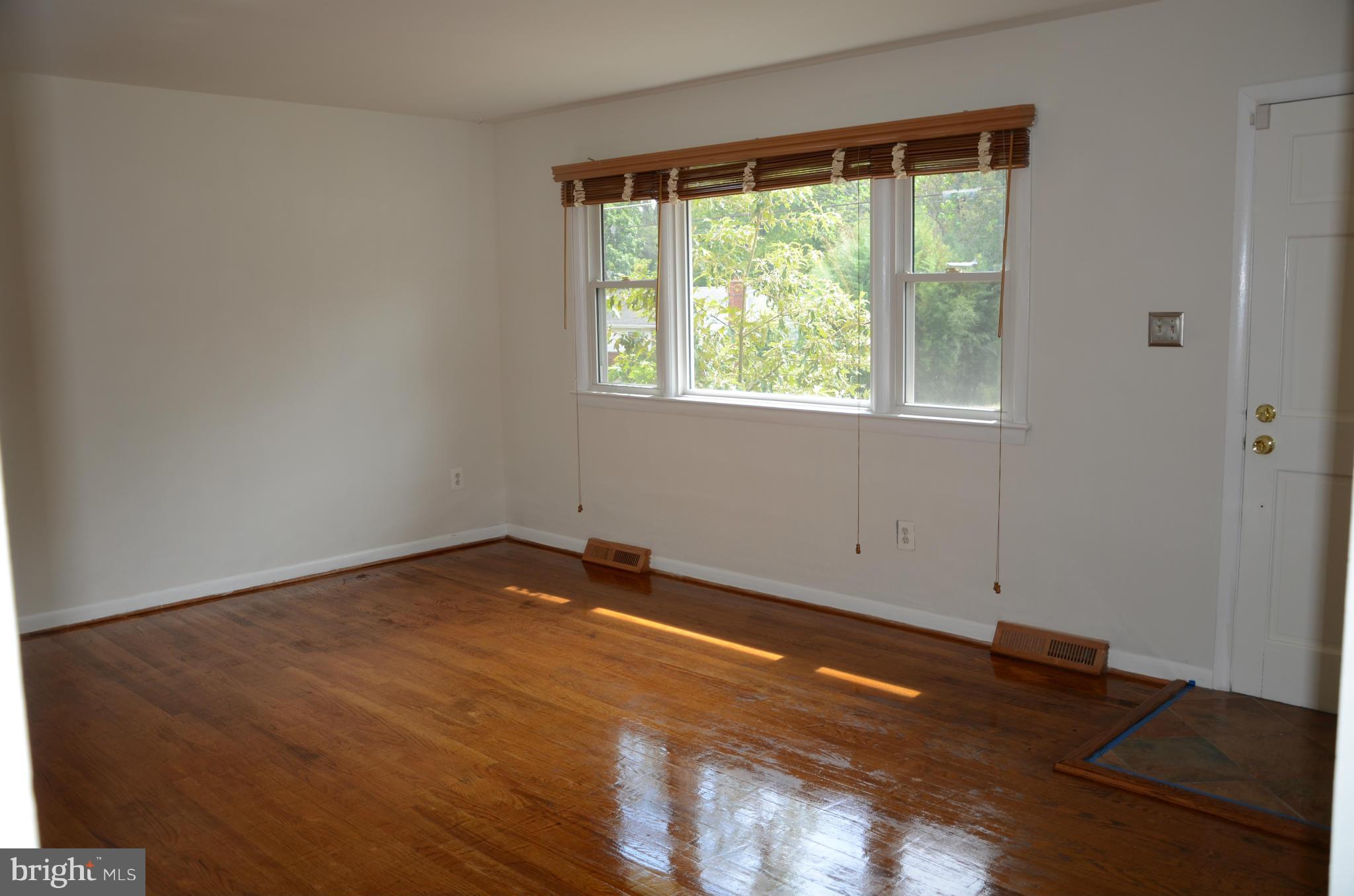 3206 Dalewood Road Fort Washington, MD 20744 - Photo 2 of 18 an empty room with wooden floor and windows