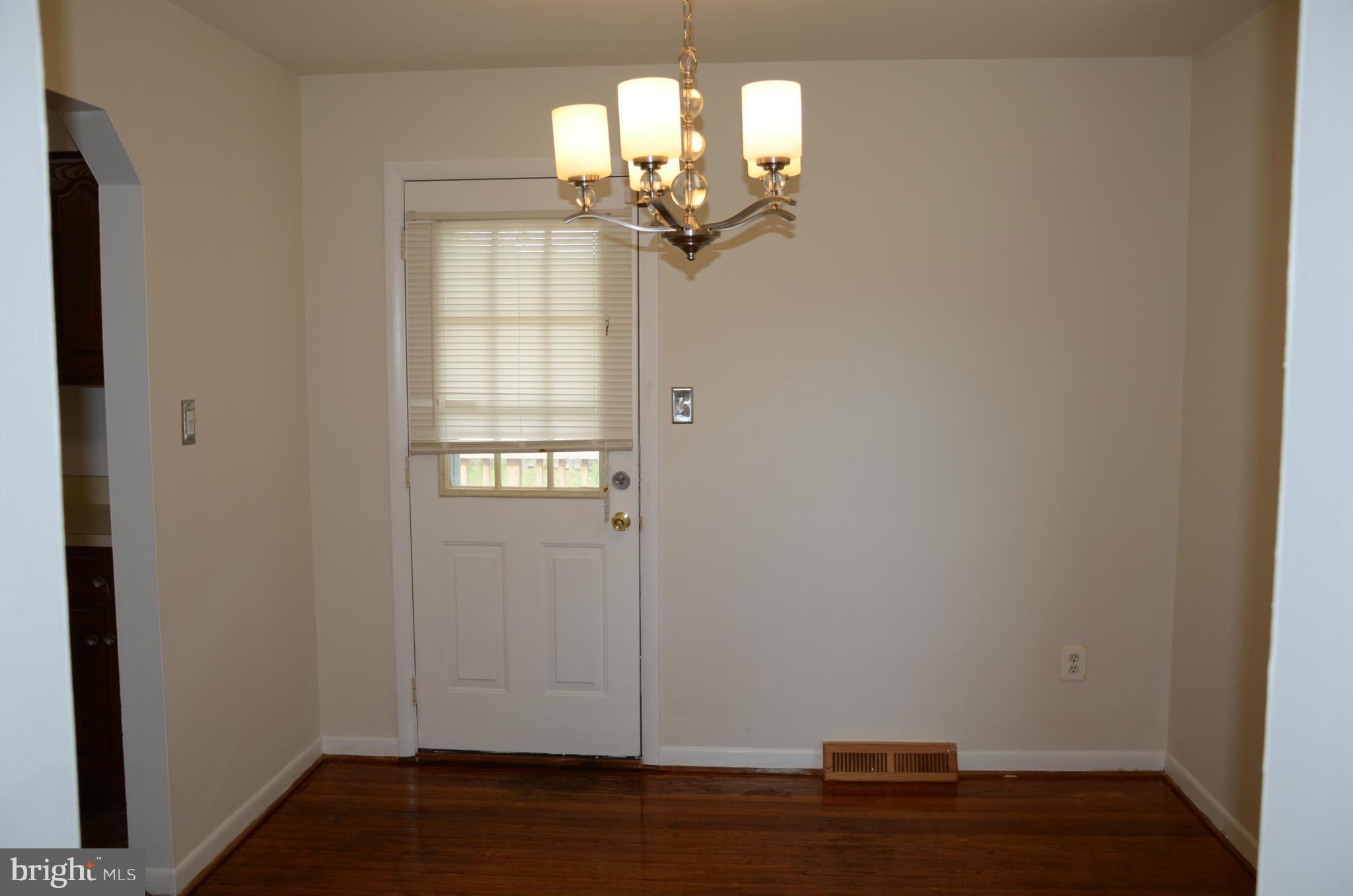 3206 Dalewood Road Fort Washington, MD 20744 - Photo 3 of 18 a view of a room with wooden floor and chandelier