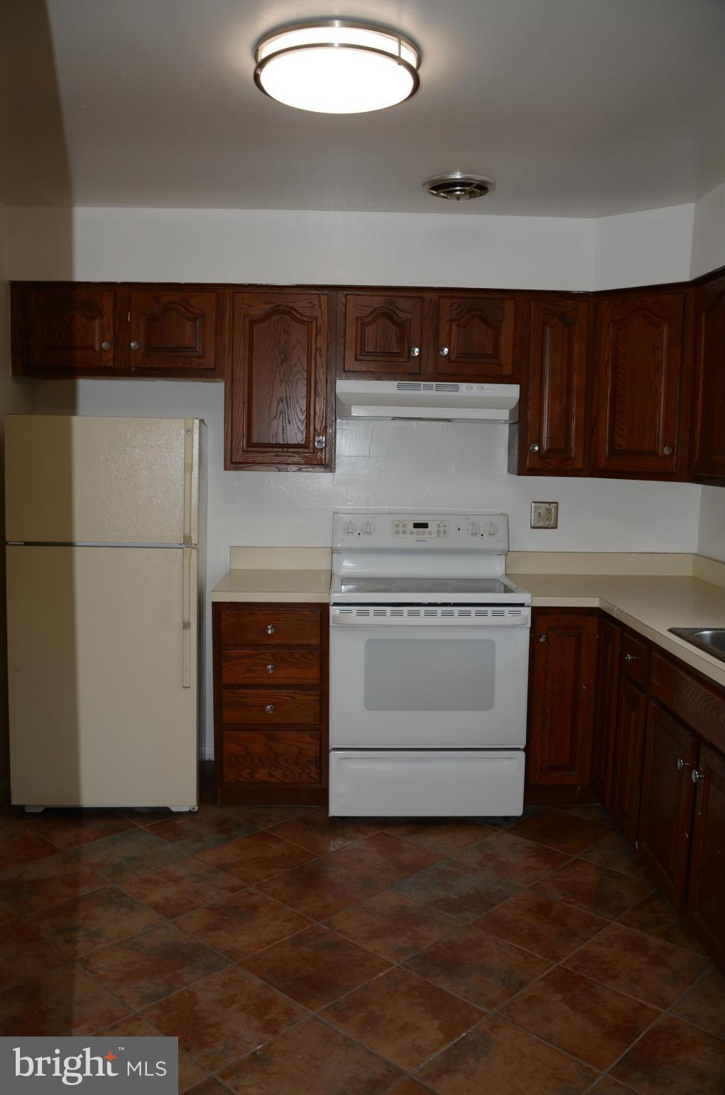 3206 Dalewood Road Fort Washington, MD 20744 - Photo 5 of 18 a kitchen with a stove cabinets and wooden floor