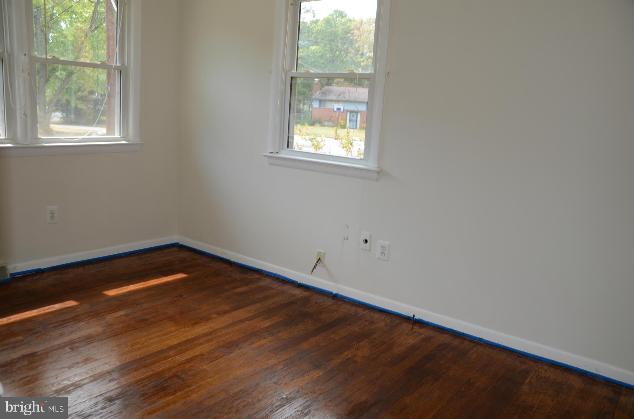 3206 Dalewood Road Fort Washington, MD 20744 - Photo 7 of 18 a view of an empty room with wooden floor and a window