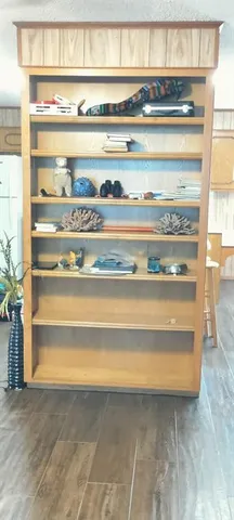 a kitchen with a wooden floor and a large window