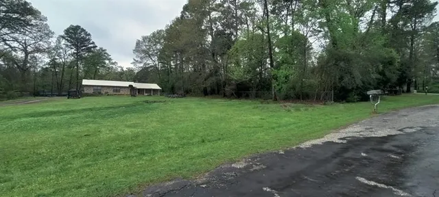 a backyard of a house with lots of green space and fountain