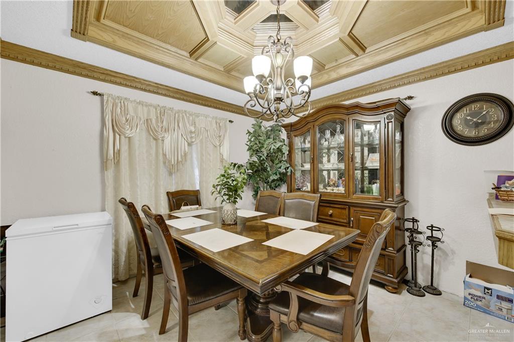 309 Domingo Navarez Street Rio Grande City, TX 78582 - Photo 7 of 14 Dining room with crown molding, suspended lighting, coffered ceiling, and light tile patterned floors