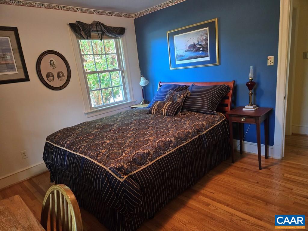 701 4th Avenue Farmville, VA 23901 - Photo 17 of 29 a bed sitting in a bedroom next to a window with a bookshelf and a bookshelf