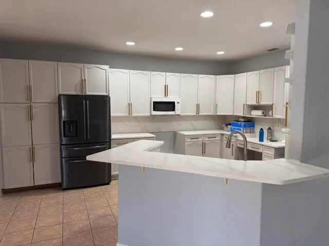 a kitchen with refrigerator and a sink