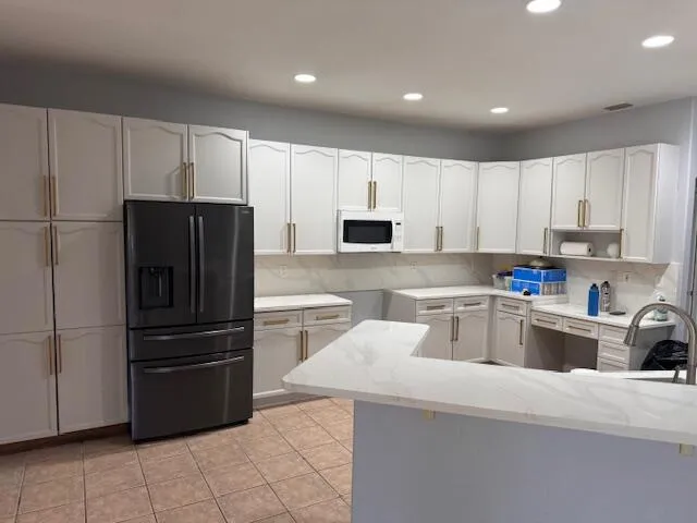 a kitchen with cabinets and stainless steel appliances