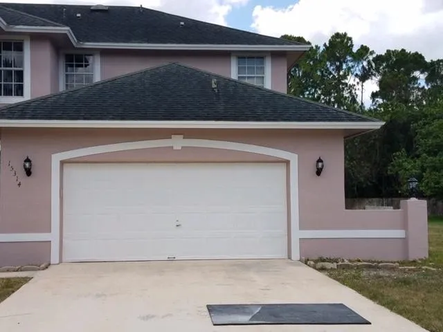 a front view of a house with garage