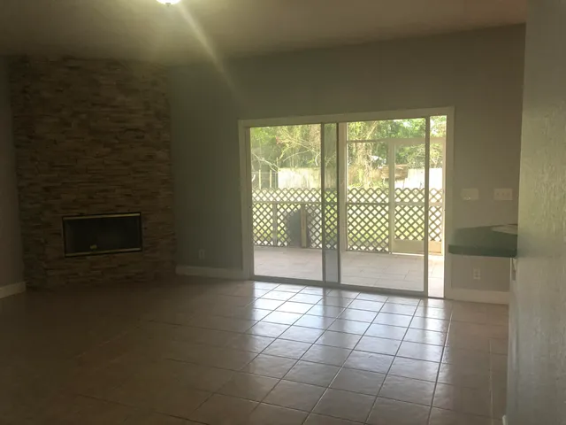a view of an empty room with a fireplace
