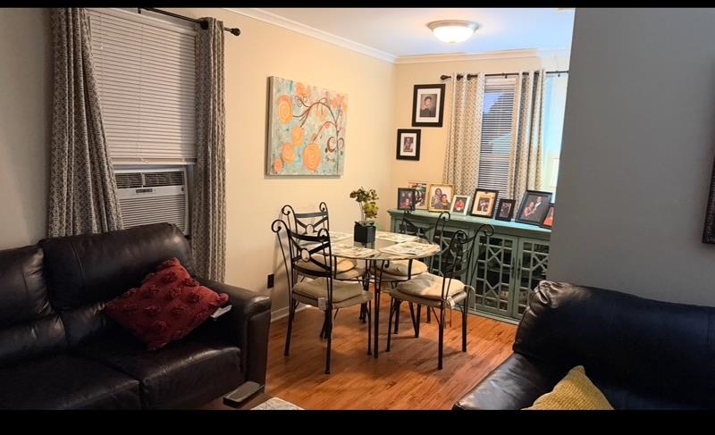 476 Jenson Road Memphis, TN 38109 - Photo 12 of 17 Dining space featuring ornamental molding, light wood-style flooring, and cooling unit