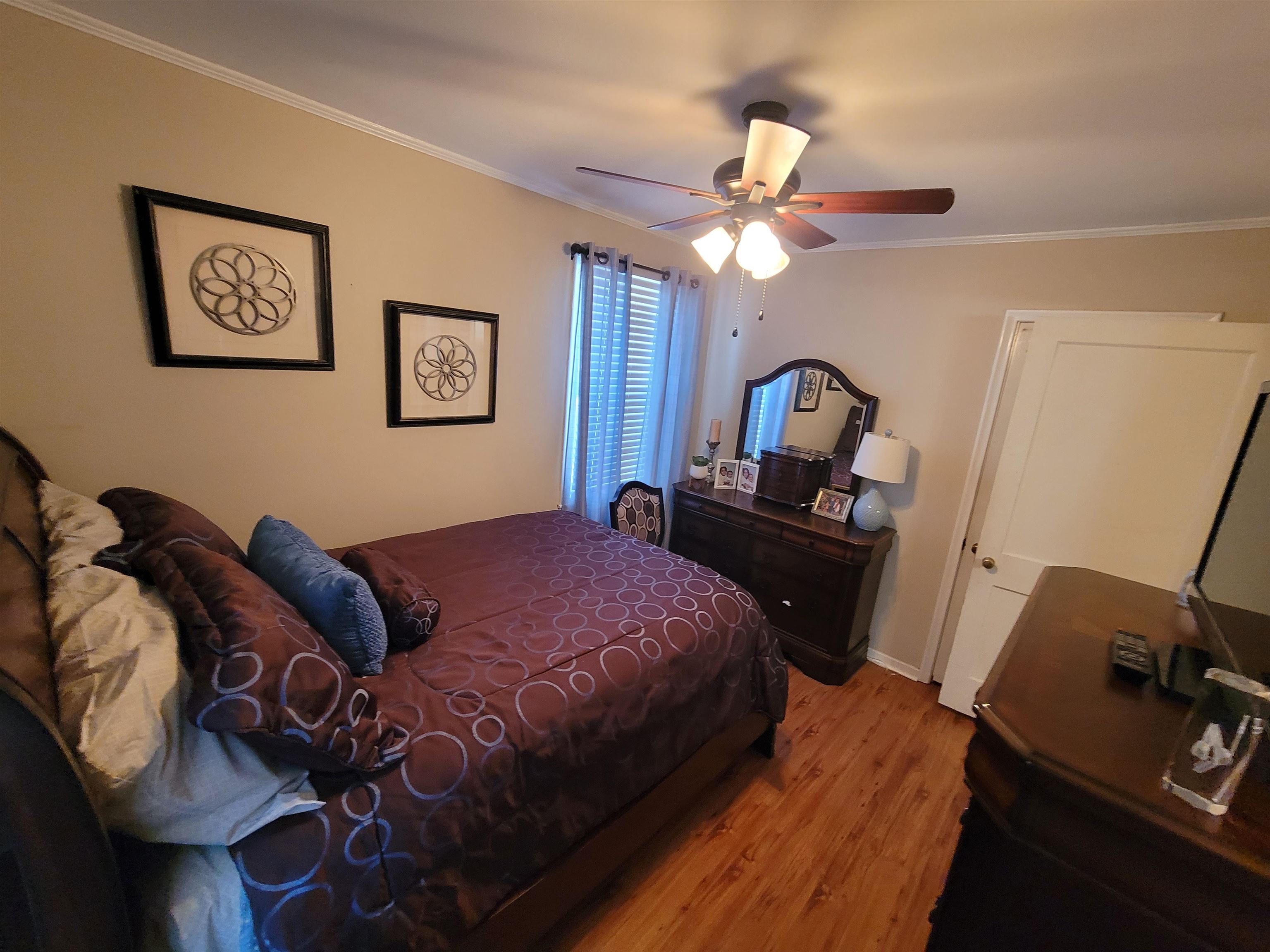 476 Jenson Road Memphis, TN 38109 - Photo 25 of 30 a bedroom with a bed and a chandelier