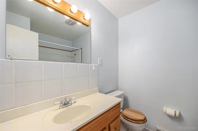 a living room with furniture and stairs