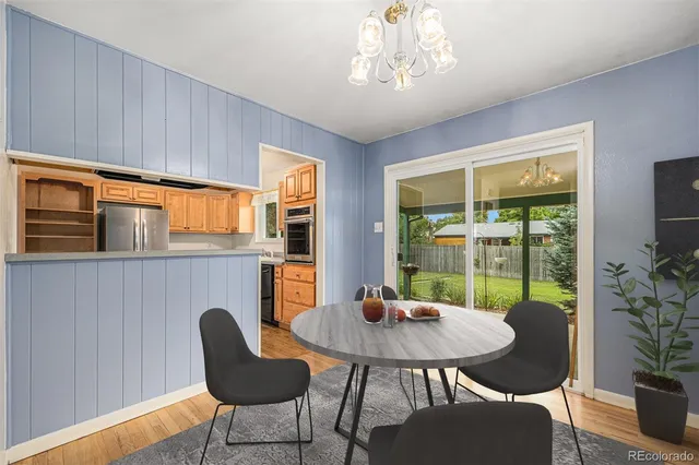 a kitchen with a refrigerator and a stove top oven