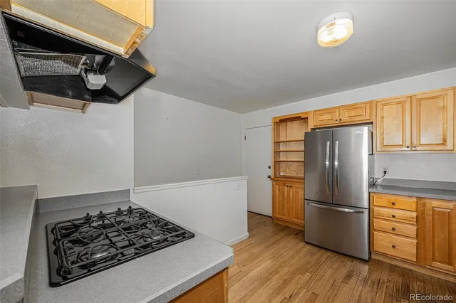 a kitchen with stainless steel appliances granite countertop a stove a sink and a refrigerator