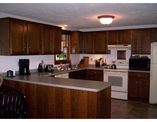 9 Potter Road Douglas, MA 01516 - Photo 3 of 26 a kitchen with a sink a stove and cabinets