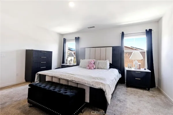 a bedroom with a bed and window