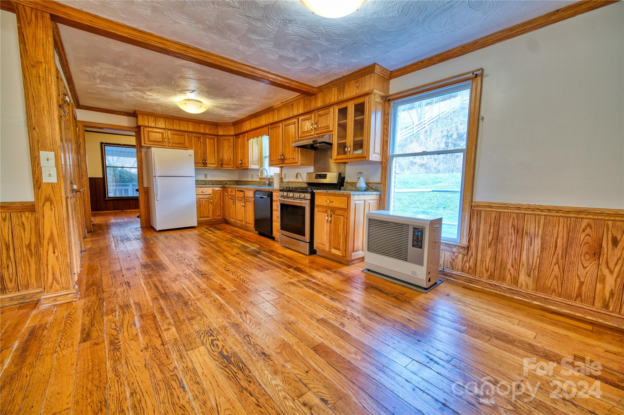 181 Colt Creek Road Lansing, NC 28643 - Photo 20 of 40 a view of a large kitchen with wooden floor and a sink