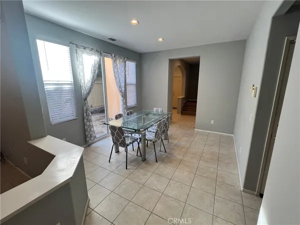 a view of a dining room with furniture and a window