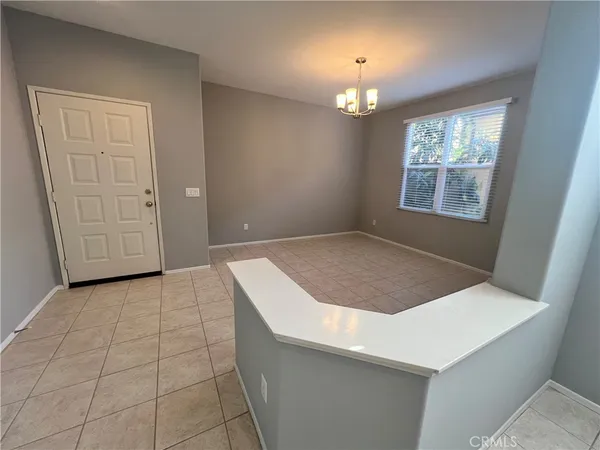 an empty room with windows and entrance