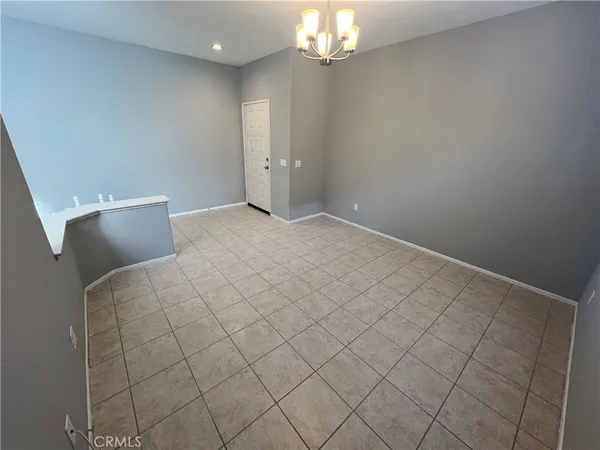 a view of a livingroom with an empty space and a window