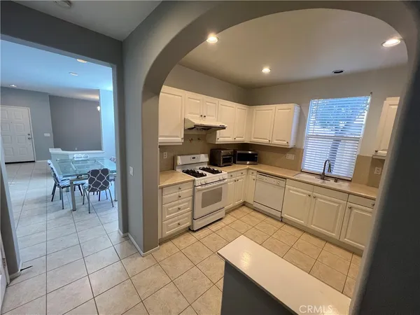 a kitchen with cabinets appliances and a window