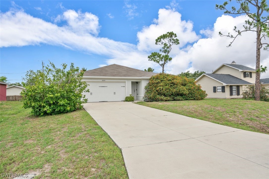 18520 Sebring Road Fort Myers, FL 33967 - Photo 24 of 24 a front view of a house with a yard and garage