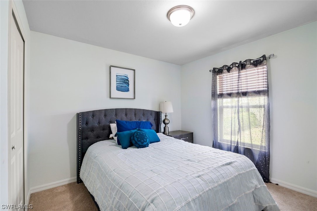 18520 Sebring Road Fort Myers, FL 33967 - Photo 4 of 24 a bedroom with a bed and a window