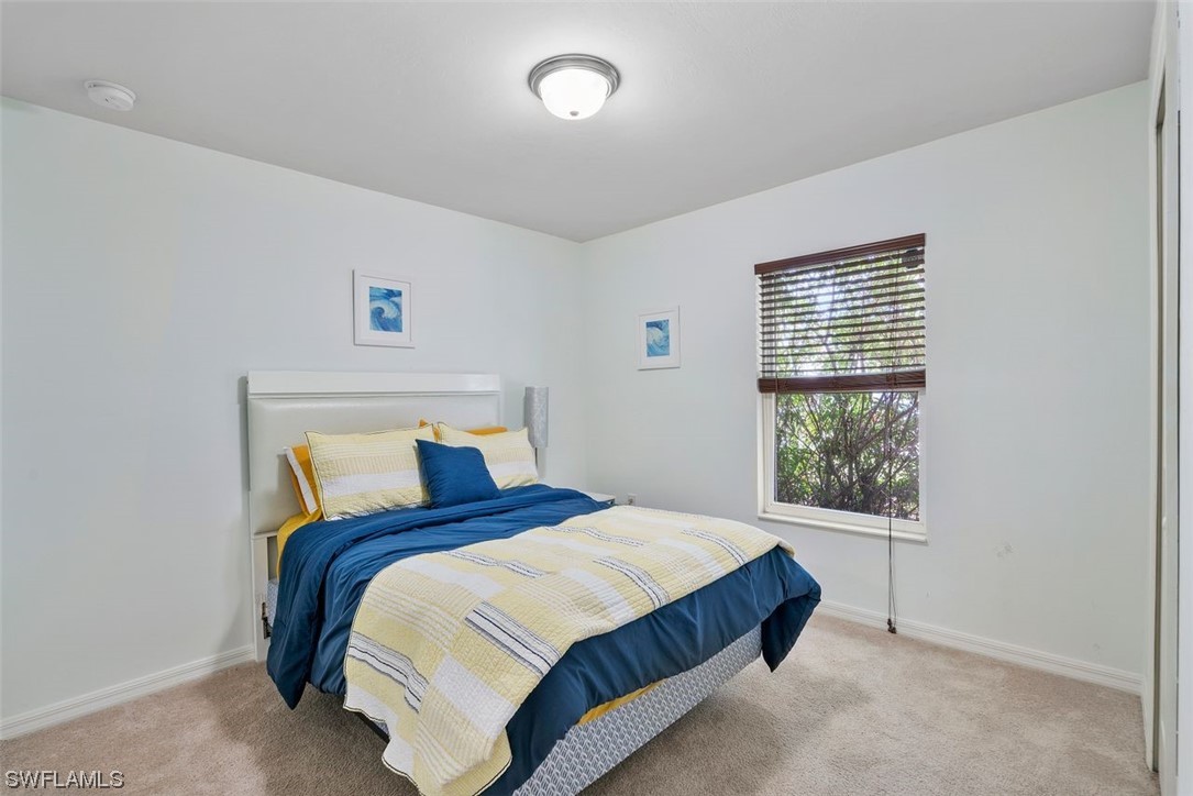 18520 Sebring Road Fort Myers, FL 33967 - Photo 5 of 24 a bedroom with a bed and window