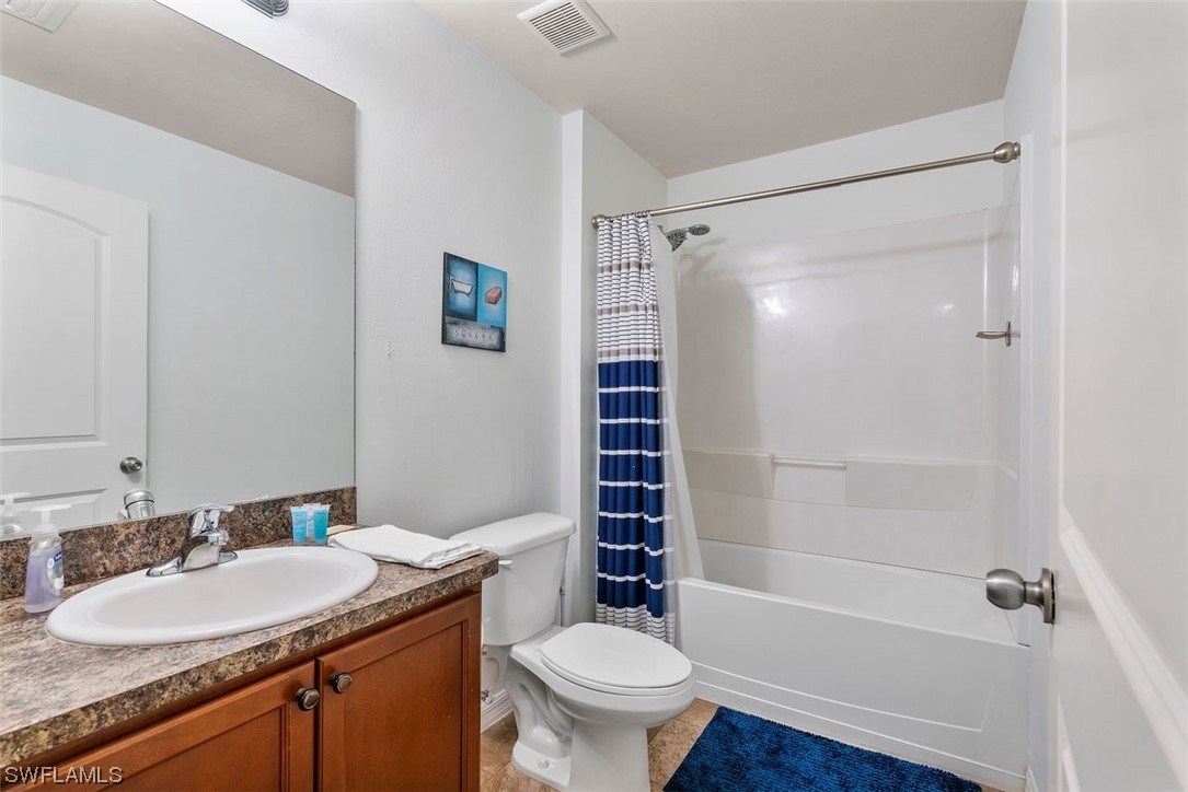 18520 Sebring Road Fort Myers, FL 33967 - Photo 6 of 24 a bathroom with a granite countertop sink toilet and shower