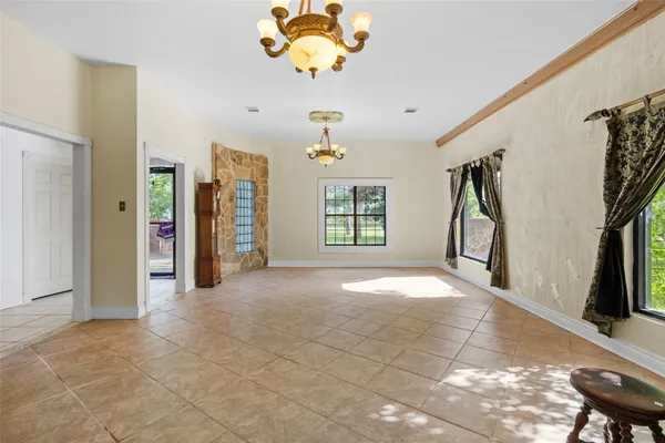a living room with a table and a fireplace