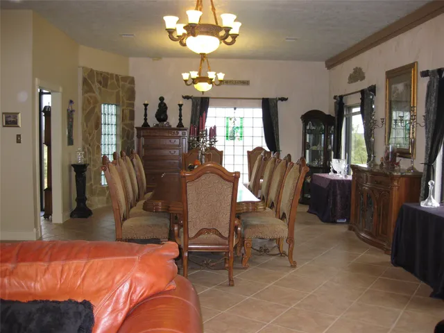 a living room with fireplace furniture and a large window