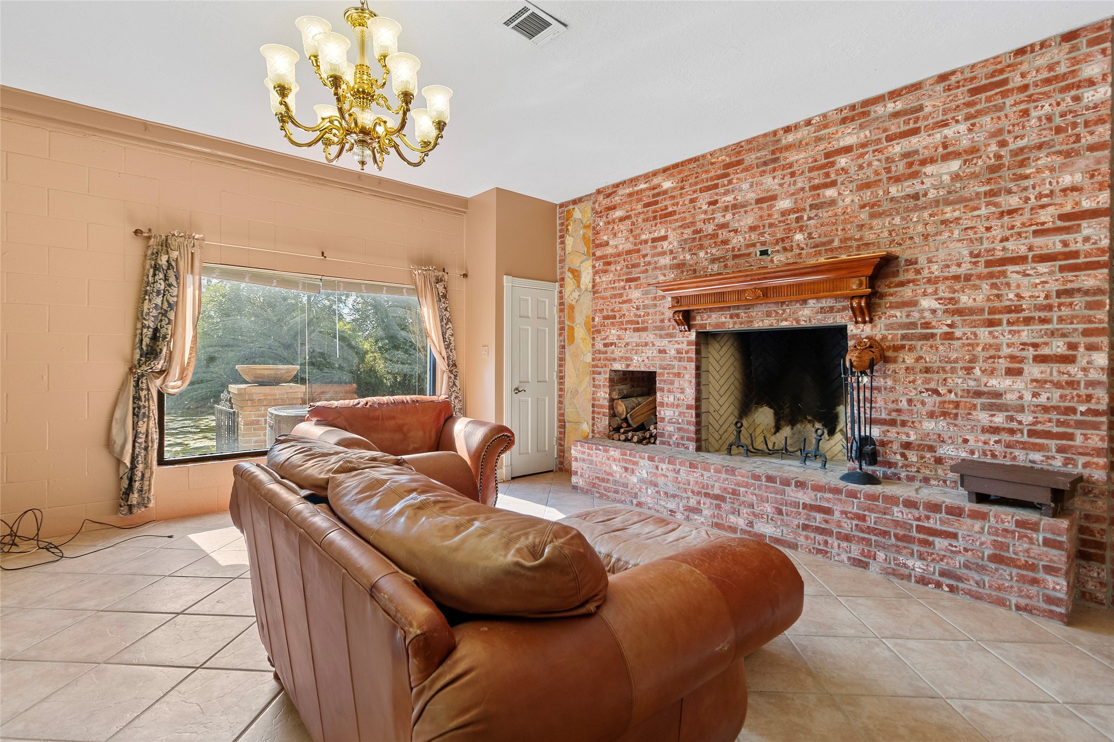 29315 Stockdick Road Katy, TX 77493 - Photo 18 of 50 a living room with furniture a fireplace and a floor to ceiling window