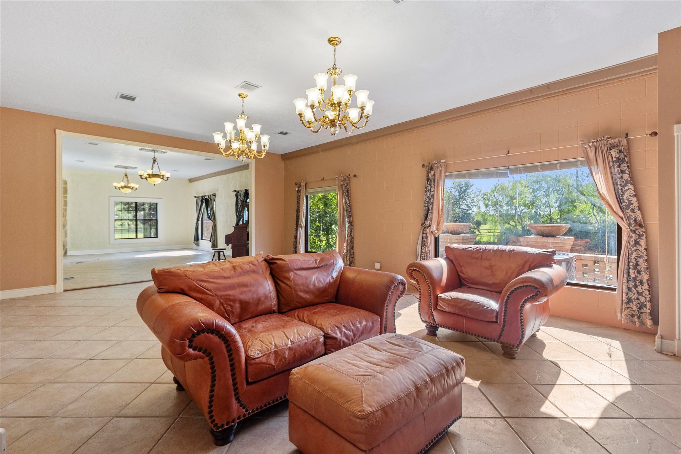 29315 Stockdick Road Katy, TX 77493 - Photo 20 of 50 a living room with furniture a chandelier and a dining table