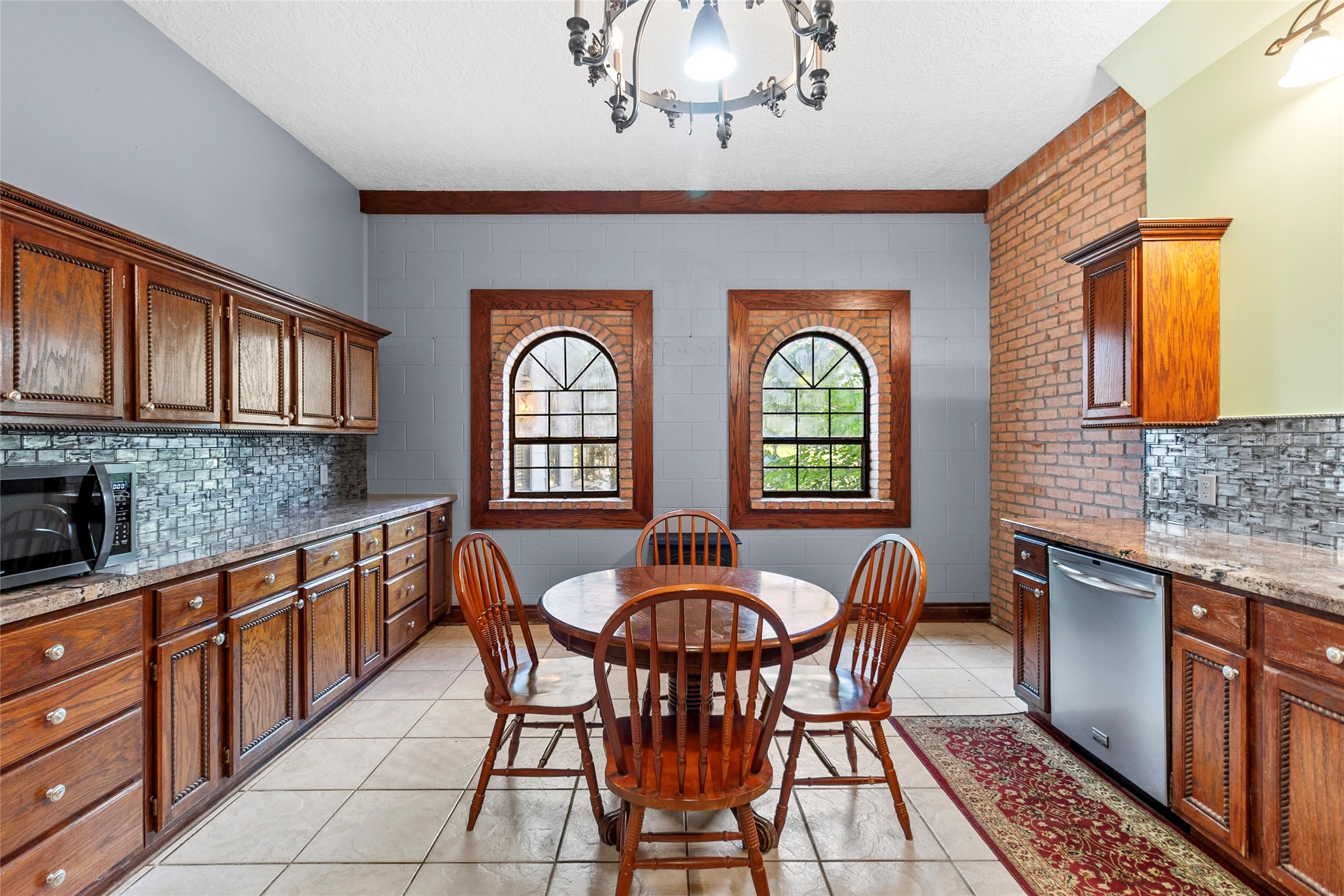 29315 Stockdick Road Katy, TX 77493 - Photo 22 of 50 a dining room with chandelier fan and wooden furniture