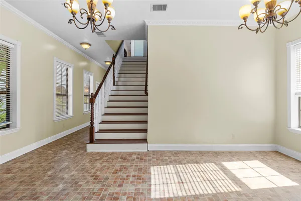 a living room with furniture a dining table and a window