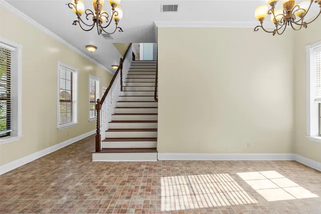 a living room with furniture a dining table and a window
